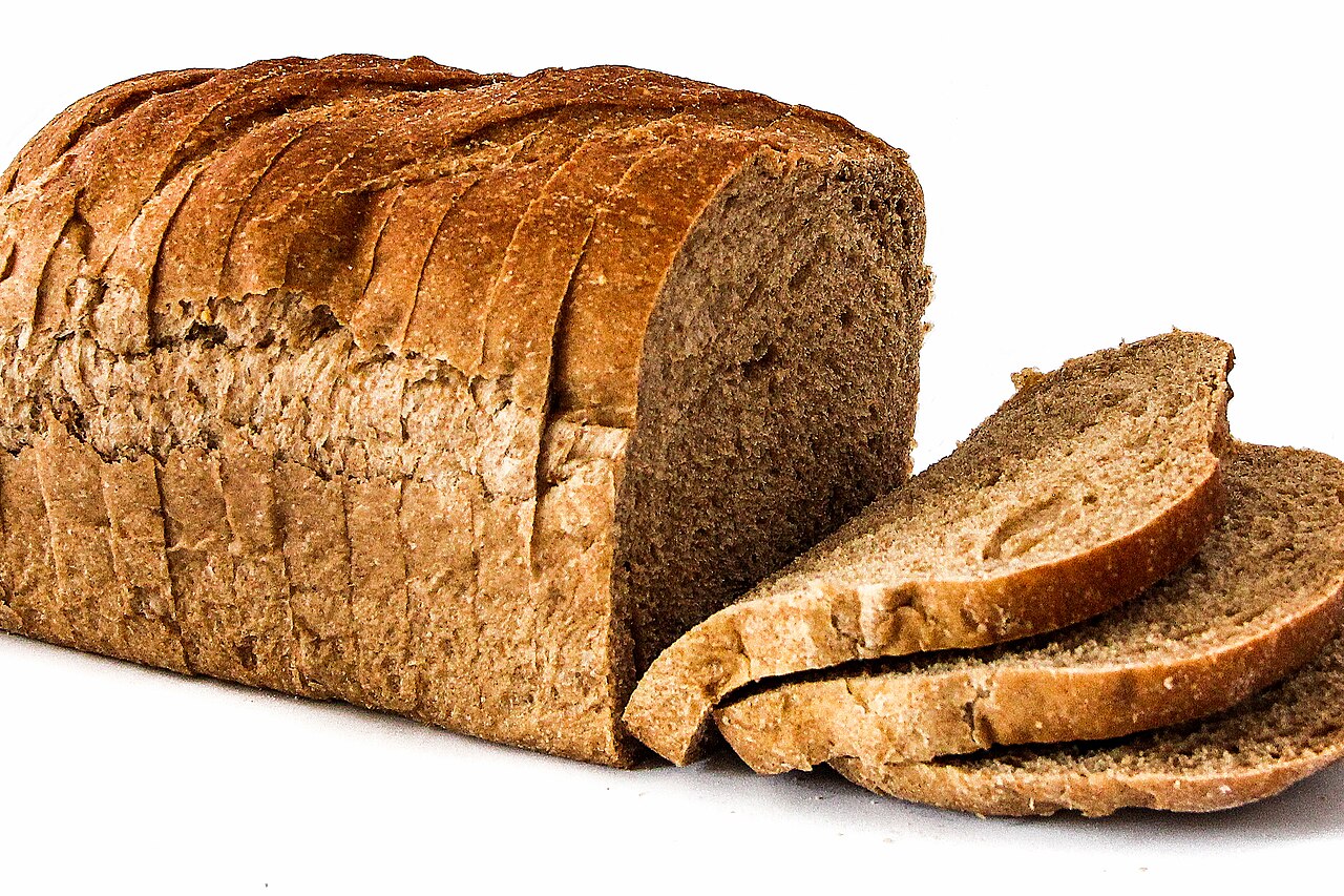 A sliced loaf of brown bread