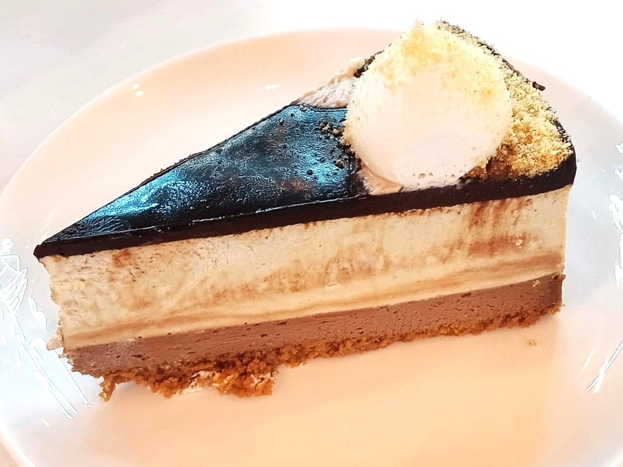 A slice of cake with cream on a plate