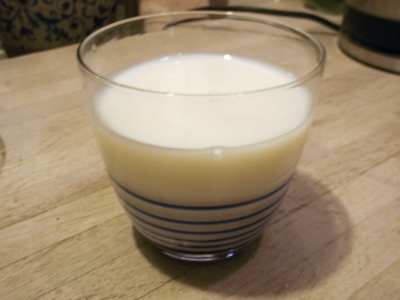 A glass of milk on a wooden table