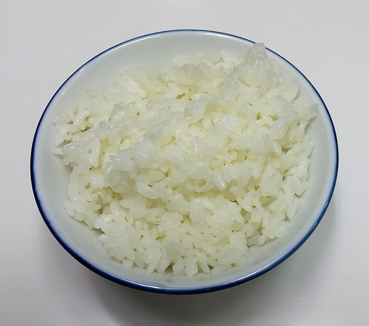 A white bowl of cooked white rice